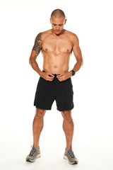 Model tying the drawstring in his black Rep Shorts. Men's gym shorts with a drawstring for a comfortable fit.