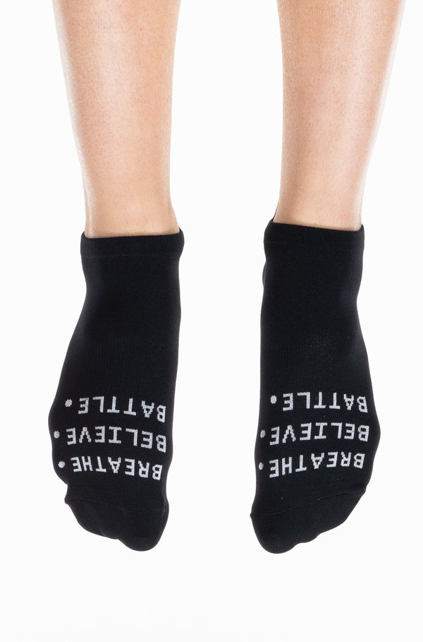 Black ankle socks with Breath. Believe. Battle. logo. Supportive running socks.